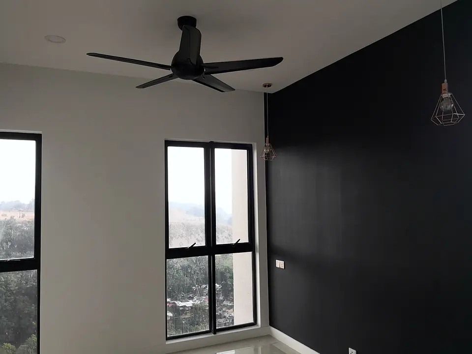Bedroom with a dark feature wall and a pendant light