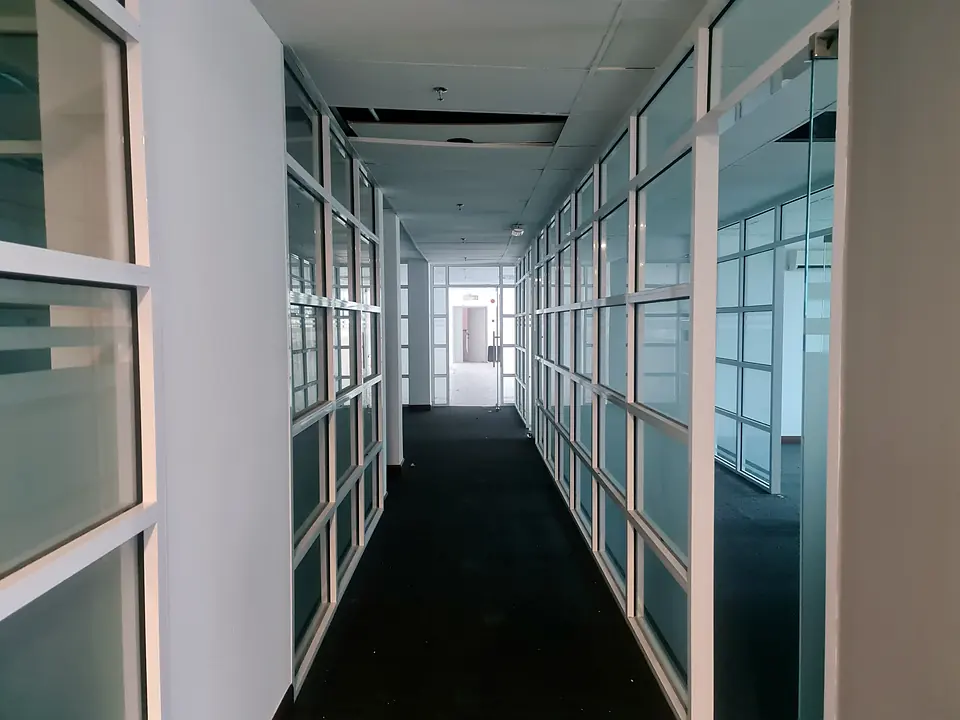 Office corridor lined with glass partitions